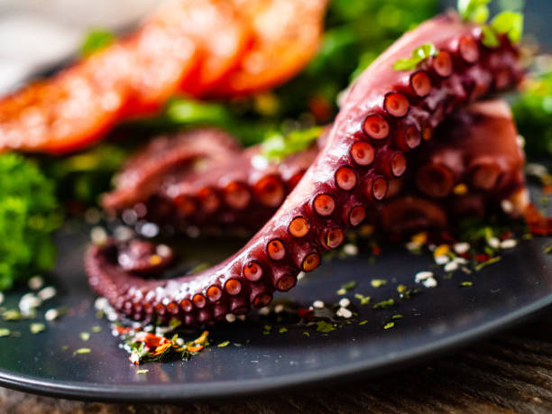 istock Fried octopus and vegetables on wooden table 1212742127