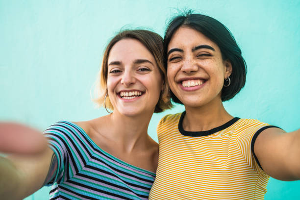 istock Lovely lesbian couple taking a selfie. 1212742204