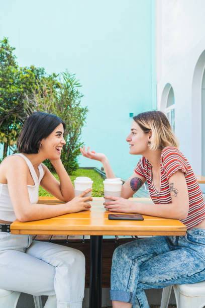 istock Loving lesbian couple having a date at coffee shop. 1212742221