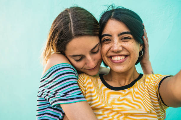 istock Lovely lesbian couple taking a selfie. 1212742229