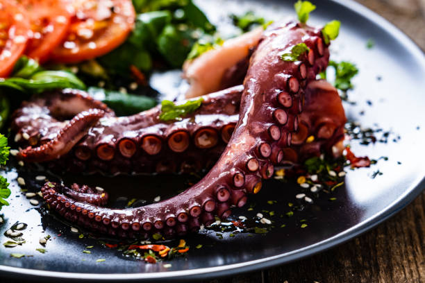 istock Fried octopus and vegetables on wooden table 1212742336