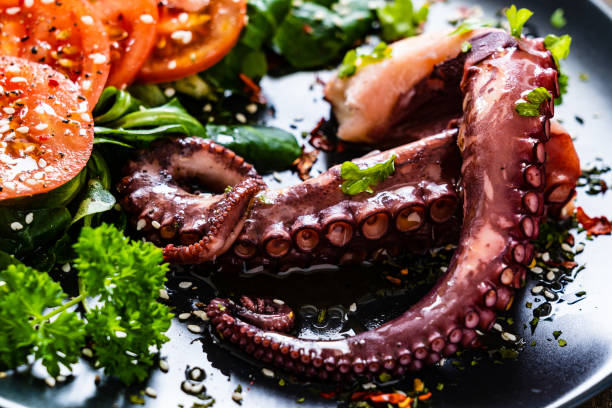 istock Fried octopus and vegetables on wooden table 1212742408