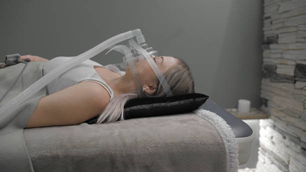 istock Girl lies on bed with artificial respiration mask 1212743057