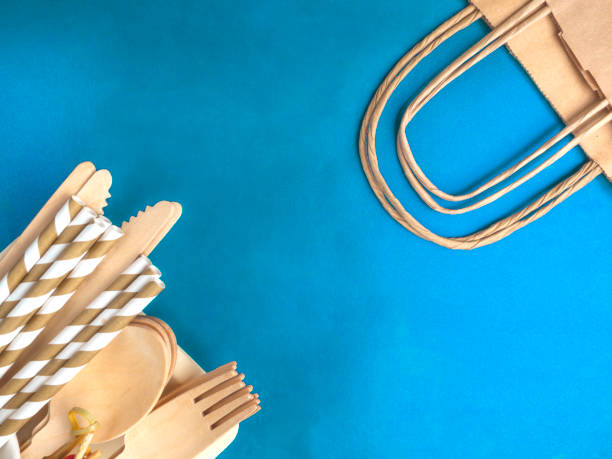 istock Disposable wooden cutlery on blue background 1212743534