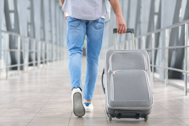 istock Transit Passenger Concept. Unrecognizable Man Walking With Suitcase In Airport Terminal 1212744006
