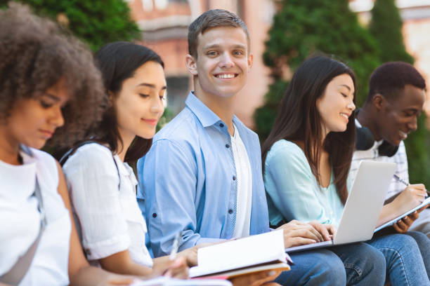 istock College students studying ioutdoors, preparing for exams together 1212745761