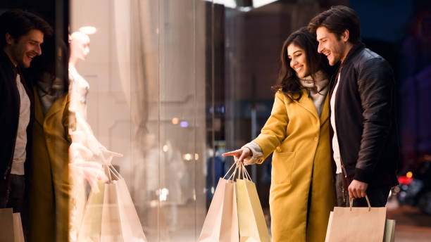 istock Woman showing something in mall window to her husband 1212746543