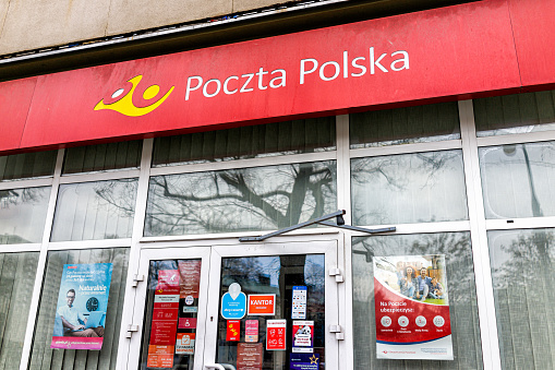 Warsaw, Poland - December 25, 2019: Entrance door with facade to Poczta Polska or Polish Post Office branch in Warszawa with nobody