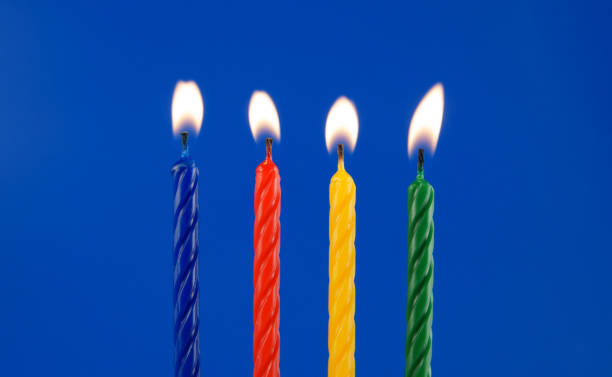 istock Colorful birthday candles on blue background 1212746778