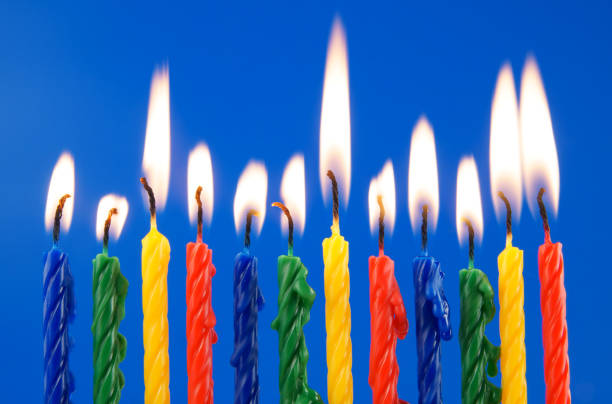 istock Colorful birthday candles on blue background 1212746807