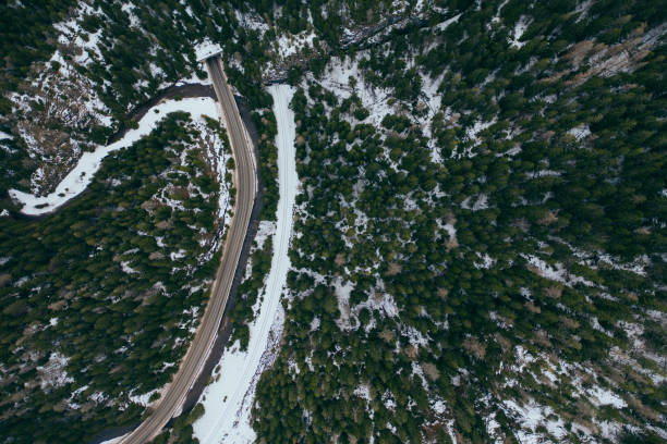istock road in snow covered forest, top down aerial view 1212746876