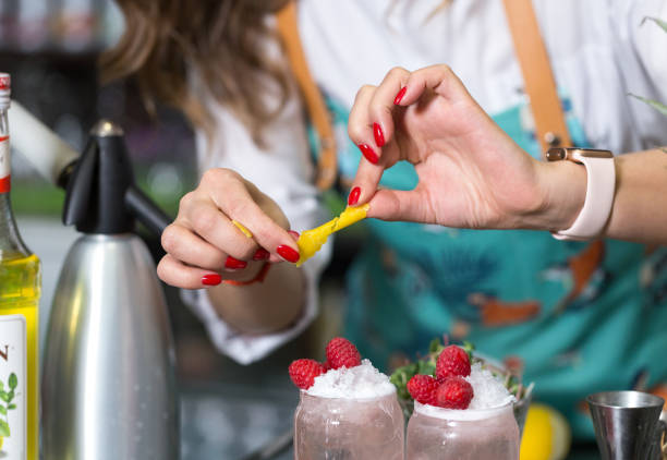 istock Hands of a professional bartender decorate a cocktail. 1212747864