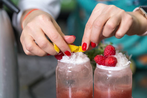 istock Hands of a professional bartender decorate a cocktail. 1212747905