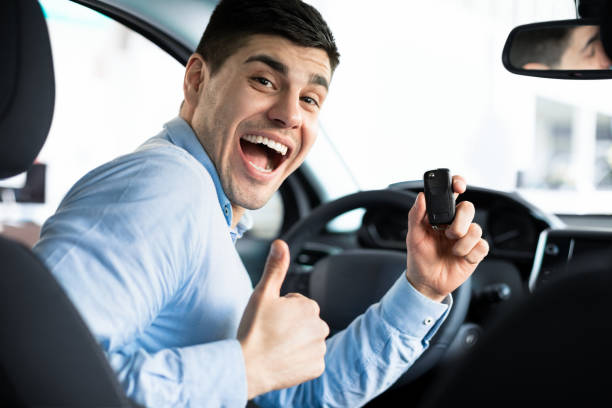 istock Man Showing Car Key And Thumb Up 1212748133
