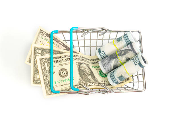 istock a basket with blue inserts inserted on a small cropped bills and hundred-dollar rolls on a white background. isolate 1212748323