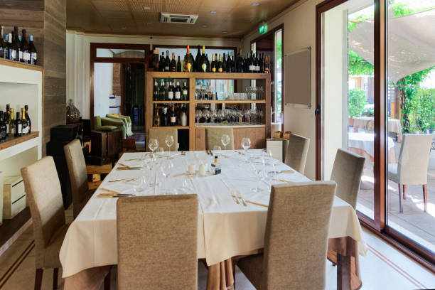 istock Retro restaurant interior with wine shelves and tables with chairs 1212749573