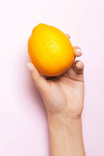 istock Woman hand with lemon 1212750769