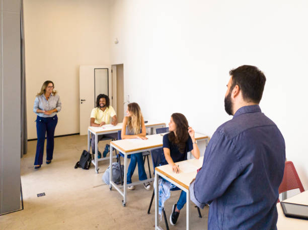 istock Students and  teacher in a classroom. 1212750790