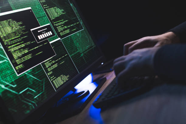 istock Typing on a keyboard with data on a monitor 1212752225