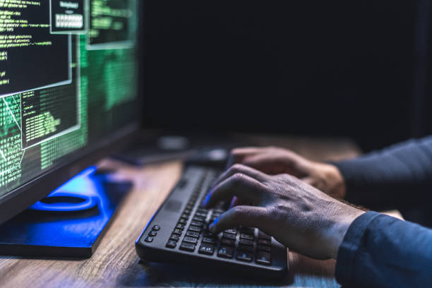 istock Typing on a keyboard with data on a monitor 1212752382