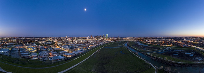 Panoramic aerial drone picture of Dallas skyline and Trammel Crow Park at sunset