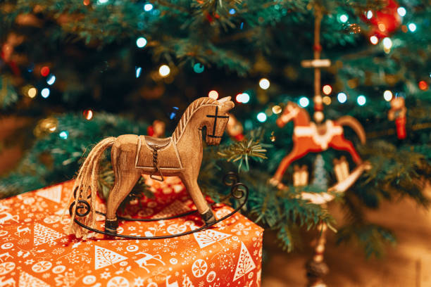 istock Toy horse decorations underneath a Christmas tree 1212757116