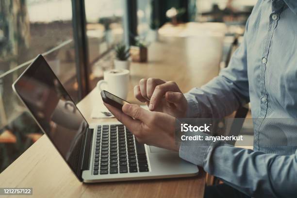 Social Media Closeup Of Hands Holding Smartphone In Cafe Stock Photo - Download Image Now