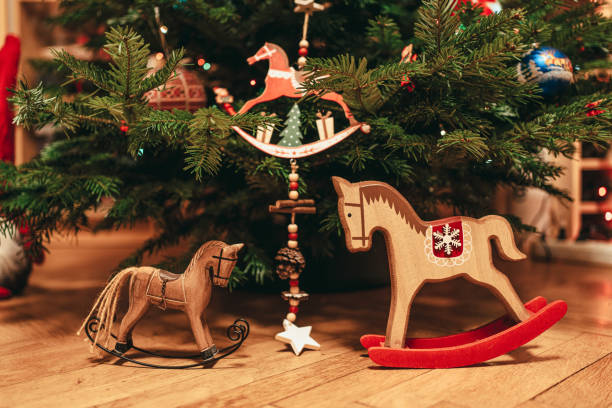 istock Toy horse decorations underneath a natural Christmas tree 1212757216
