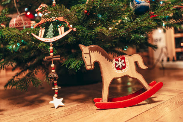 istock Toy wood horse underneath the Christmas tree 1212757318