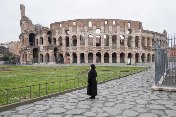 A woman in front of the Coliseum in Rome stock photo