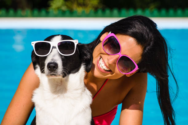 istock Woman and cute dog having fun on summer vacation 1212758480