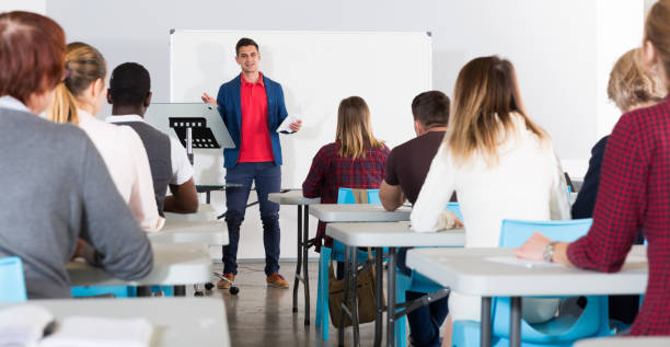 istock Male student answering at whiteboard 1212759260