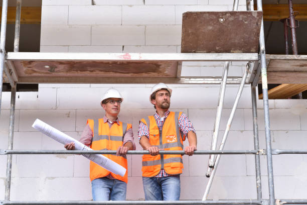 istock construction manager and architect on site during the construction of a house - planning and control on site - teamwork 1212759306