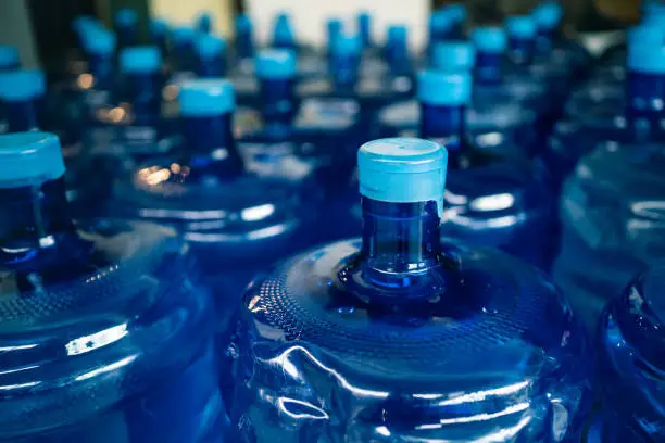 A pile of large drinking water bottles