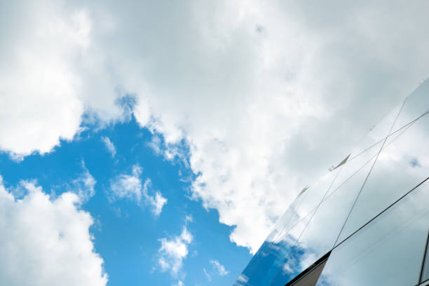istock Mirrored Window Office Building Exterior Reflecting Clouds Covering Blue Sky in Miami Beach 1212760314