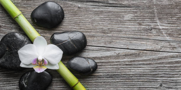 istock Black stones ,orchid flower and bamboo 1212760438