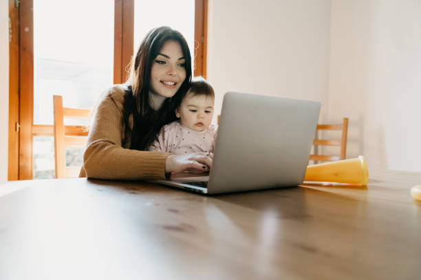 istock A young mother is working at home using computer while she's taking care of her daughter 1212761091