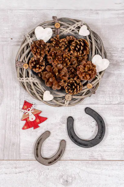 Horse themed christmas decoration with horseshoes. Suitable for horse riding theme greetings, postcards, backgrounds and social media posts just in time for Christmas.