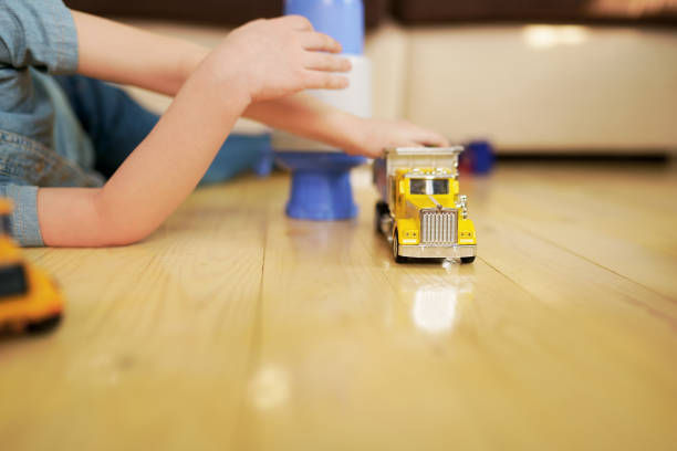 Little boy playing with toy car in the room Little boy playing with toy car in the room kid toy car stock pictures, royalty-free photos & images