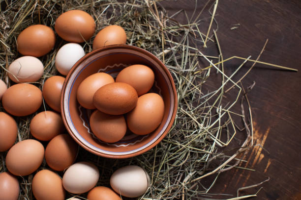 istock Homemade chicken Easter eggs lie on hay and in a bowl 1212762399