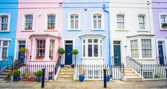 A row of multi-coloured townhouses in London's Kensington and Chelsea district.