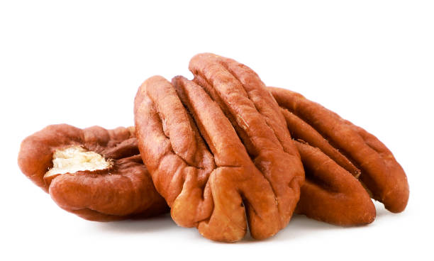 istock Peeled pecan nuts close-up on a white. Isolated 1212764132