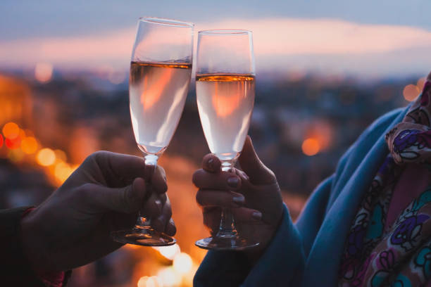 couple drinking champagne or wine in luxury hotel restaurant