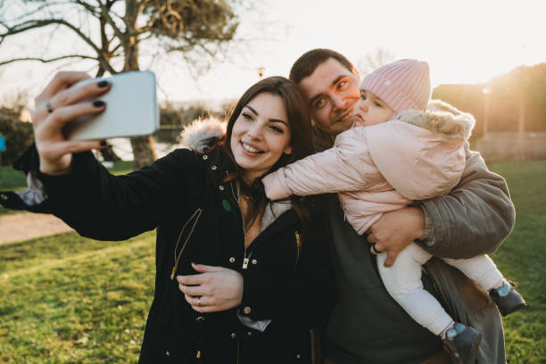 istock Family taking a selfie at the park 1212764703