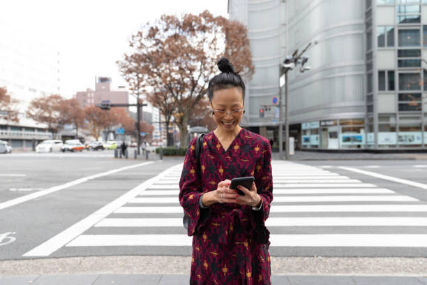 istock Japanese business worman walking with suitcase 1212765832