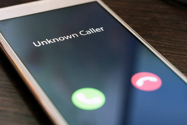 Unknown caller. Smartphone with incoming call from an unknown number at night. Incognito or anonymous stock photo