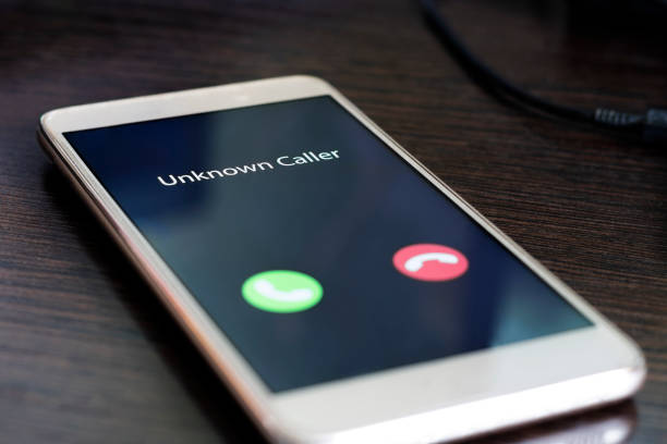 Unknown caller. Smartphone with incoming call from an unknown number at night. Incognito or anonymous stock photo