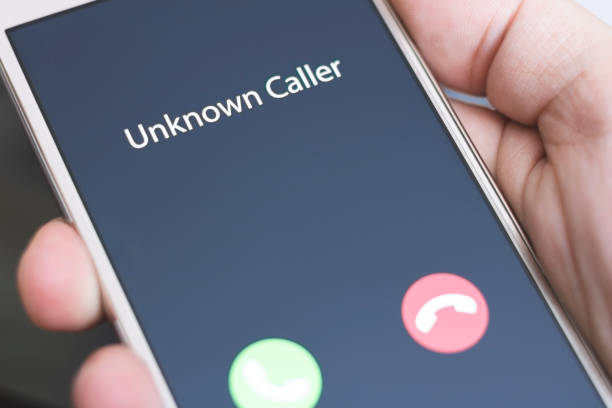 istock Unknown caller. A man holds a phone in his hand and thinks to end the call. Incoming from an unknown number at night. Incognito or anonymous 1212770121
