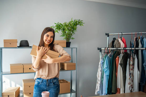 istock Young start up small business owner packing cardboard box at workplace 1212770253