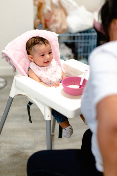 istock Feeding Time with Mommy in High Chair 1212770446